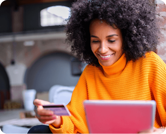Woman paying a bill on a tablet with a card