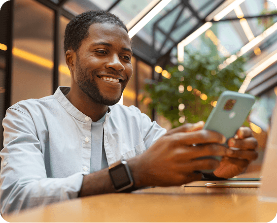Man smiling while checking his phone